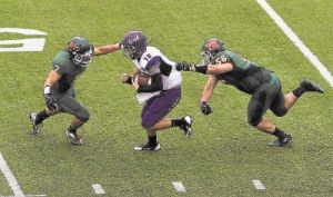 Linebacker Thomas Gilstrop (7) and defensive lineman Chris Fetterman have helped The Woodlands defense shut down the prolific offenses of A&M Consolidated and Lufkin.