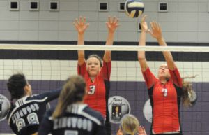 Oak Ridge’s Jackie Ward and Lacey Neeley go up for a block against Kingwood’s Sophie Zielinski on Tuesday in a Region II-5A bi-district playoff match at Humble High School.