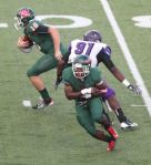 The Woodlands quarterback Chris Andritsos, left, runs upfield after faking a handoff to Patrick Carr against Lufkin. The Highlanders face Oak Ridge tonight at Woodforest Bank Stadium.