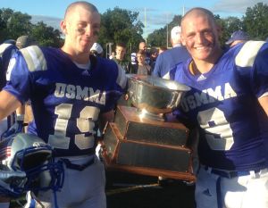 College Park High School graduate Michael Biehn poses with teammate Connor Kennedy after Merchant Marine beat Coast Guard 27-20 on Sept. 14 to win the Secretaries’ Cup.
