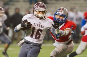 A&M Consolidated running back Derrick Dick gets away from Westlake’s Tate Shaw during the first half of the Tigers’ 41-16 win over the Chaparrals
