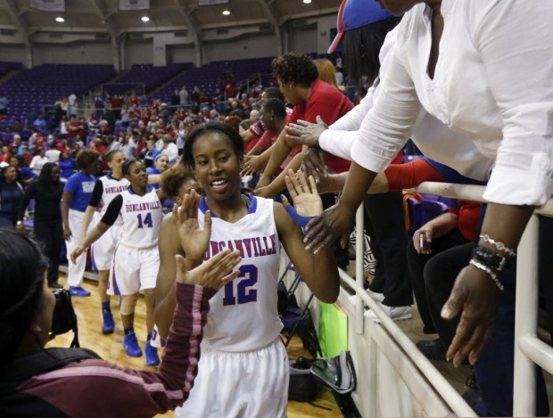 Duncanville's Ariel Atkins (12) celebrates their victory over LD Bell, with fans, after their Class 5A Region I semifinal girls basketball game held at TCU in Fort Worth on February 22, 2014. Duncanville defeated Bell 70-29.