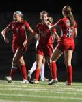 The Woodlands’ Kylie Dodson (24) ` celebrates with teammates after scoring a goal in the first half of Friday’s match against Conroe at Buddy Moorhead Memorial Stadium.
