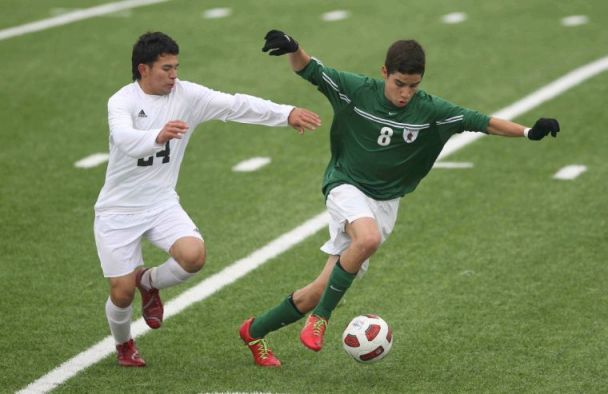 The Woodlands' Tony Arana (8) controls the ball as Conroe's Jairo Montiel (24) defends during a high school boys soccer game Wednesday. The Woodlands defeated Conroe 2-1.