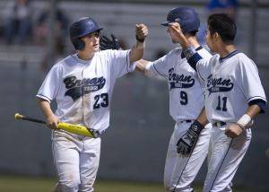 Bryan's Brandon Kveton (9) and Jeremy Pfuntner (11) congratulate Holt Van Etten after he scored to break a 0-0 tie in the sixth inning against College Park on Friday at Viking Field.