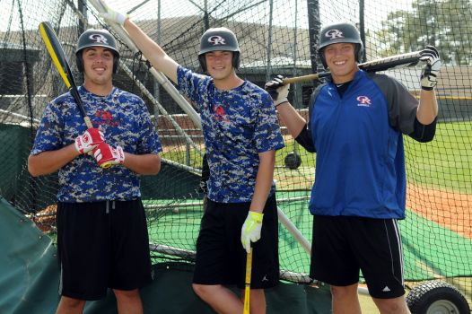 Oak Ridge senior Kim Plympton, left, senior Alex Walker, and junior Luken Baker are set for turns in the batting cage during a recent practice.