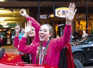 The Woodlands volleyball player Julia Pasch waves to fans during a parade in celebration of the program's second straight state volleyball title at Market Street Thursday.
