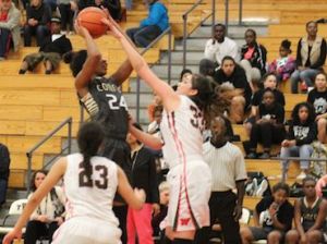 The Woodlands' Elisa Flores goes up to block a shot in the third quarter against Conroe.