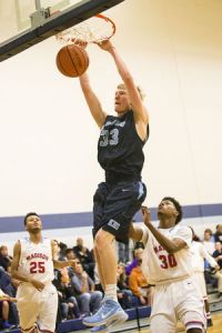Kingwood's Matt Mulloy (33) dunks during their consolation matchup against Houston Madison in The Insperity Holiday Classic on Dec. 30, 2014, at Kingwood High School.
