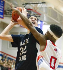 College Park's Brett Reed is fouled by Oak Ridge's Darius Love during a high school basketball game Tuesday.