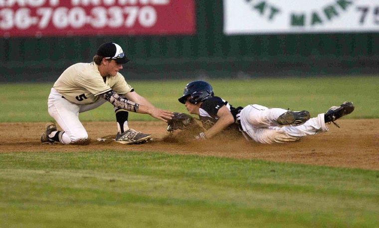 Conroe second baseman Dawson Shibley tags out Summer Creek’s Brent Wisenbaker as he tries to stretch a hit into a double in the third inning of a District 16-6A baseball game Tuesday.