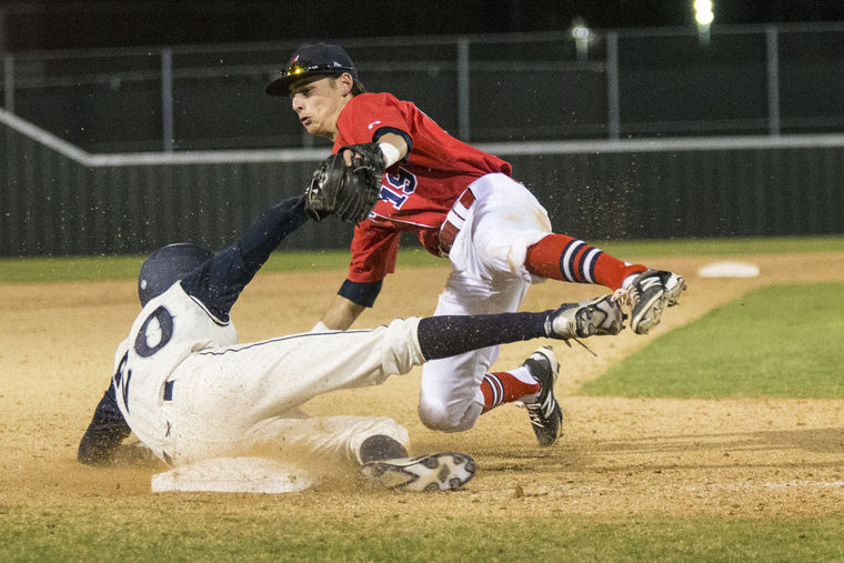 Eagles third baseman Bailey Mullins tags Flower Mound's Chad Paris (20) out during Atascocita's matchup against Flower Mound on Feb. 27, 2015, at Atascocita High School.