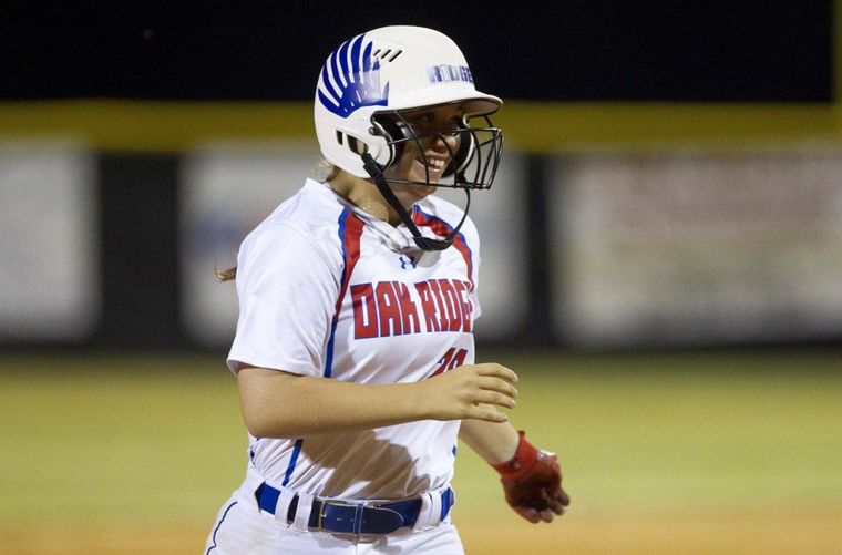 Oak Ridge’s Autumn Sydlik smiles as she comes into score after hitting a grand slam in the sixth inning. To view or purchase this photo and others like it,