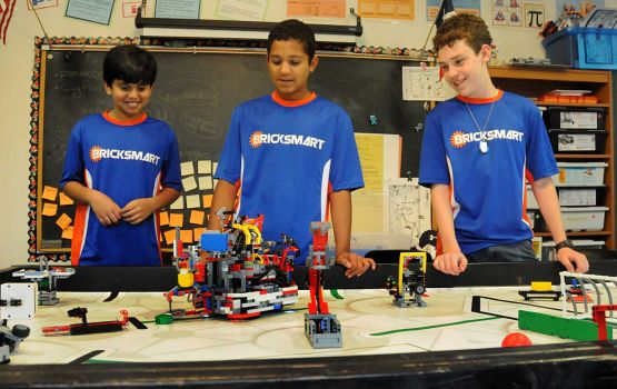 Vali Khan, Kabir Jolly, and Nick Franken watch the computer controlled Lego robotic at the Rubicon Academy, 14211 Horseshoe Bend in south Montgomery County, robotics team practice. Photograph by David Hopper.