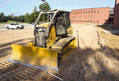 A bulldozer sits at the site of the parking lot expansion at The Woodlands High School. Parking registration is currently closed, but late registration will be open to students on August 17.