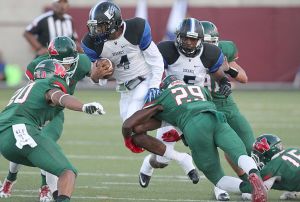 Image 8/23 Quarterback Adrian Hardy (4) of the Dekaney Wildcats is tackled by defensive back Talon Baskin (29) of The Woodlands Highlanders on Thursday, September 2, 2015 at Woodforest Bank Stadium in The Woodlands, TX.