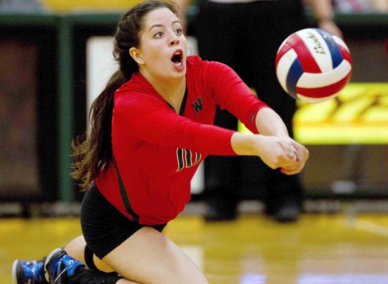 The Woodlands' Bella Pinton goes for a dig during a high school volleyball game against Katy Tuesday.
