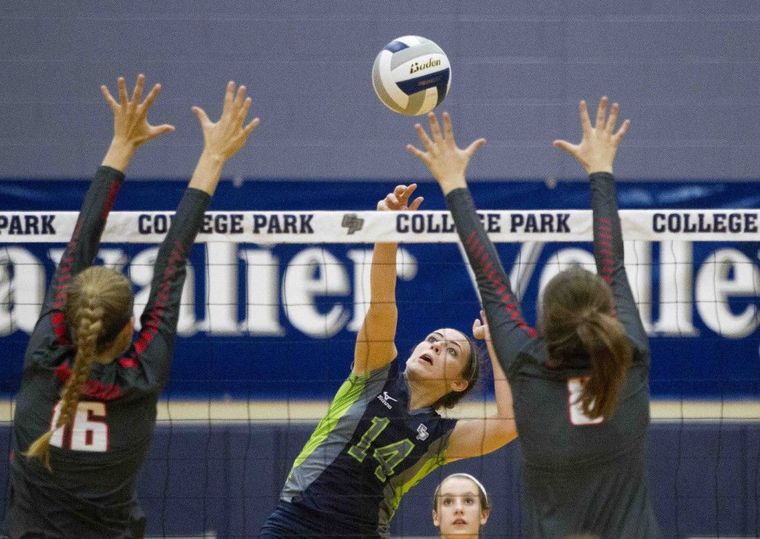 College Park’s Allicia Baurerfeld gets a shot past Memorial defense during a high school volleyball game Tuesday.
