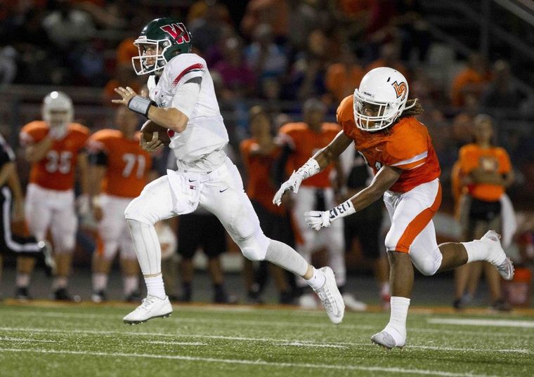 The Woodlands quarterback Eric Schmid runs for a 55-yard touchdown in the third quarter of a high school football game Friday.