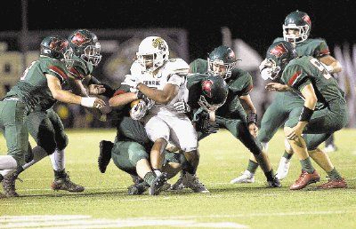 Conroe wide receiver Kameron Williams is surronded by The Woodlands' defense during a football game Friday