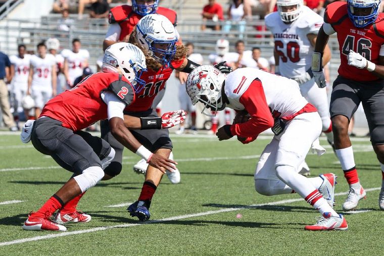 Oak Ridge's Grant Stuard (11) and Daylon Johnson (2) stop Atascocita's Alerick Soularie (12) this past Saturday at Woodforest Stadium.
