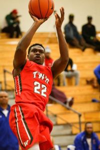 The Woodlands' Romello Wilbert (22) shoots the ball during a high school boys basketball game against Fort Bend Elkins this past Saturday night.