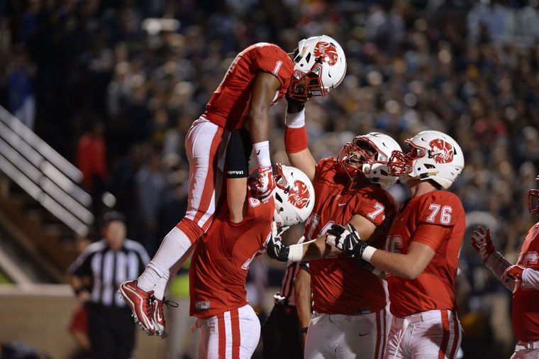 Katy linemen Hayden Howerton (75), Noah Lopez (74) and Connor Galvin (76) celebrate a touchdown catch by Tony Mullins (1) during the Tigers' Class 6A Division II area playoff against Cy Ranch, Nov. 20 at Tully Stadium in Houston. Katy won 59-20.