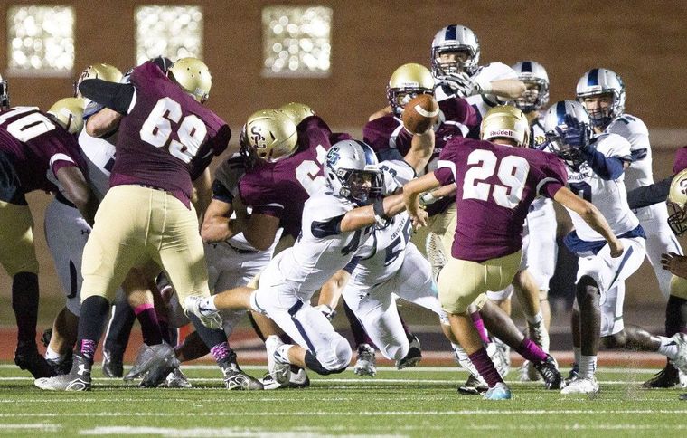 College Park linebacker Sean Milligan tries to block a extra point by Summer Creek kicker Jake Dominque during a District 16-6A football game October 22, 2015, in Humble.