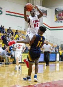 Romello Wilbert, of The Woodlands, goes up for a shot as guard Darrell Braxton, of Nimitz, defends during the first half of a boys basketball game Tuesday, Dec. 8, 2015, in The Woodlands.