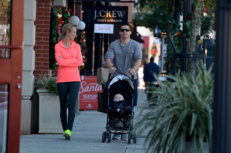 Kimberly Bonilla, from left, and her husband Will, of Spring, stroll with their son Brady, 10 months, in Market Street in The Woodlands on Dec. 4, 2015.